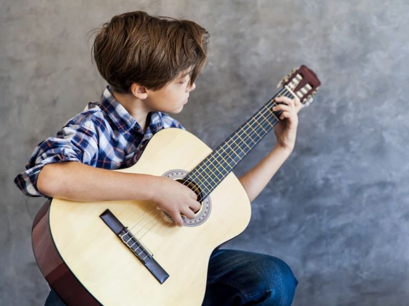 Kind spielt Gitarre